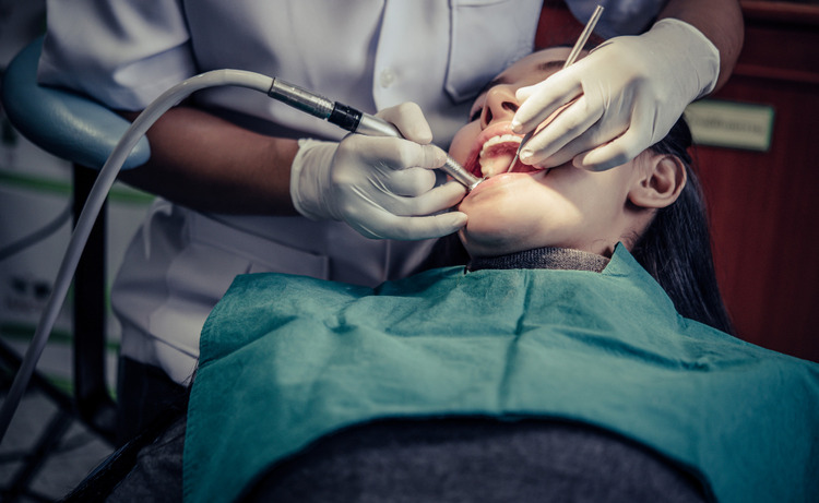 a woman during a dental filling procedure at a dentistry clinic