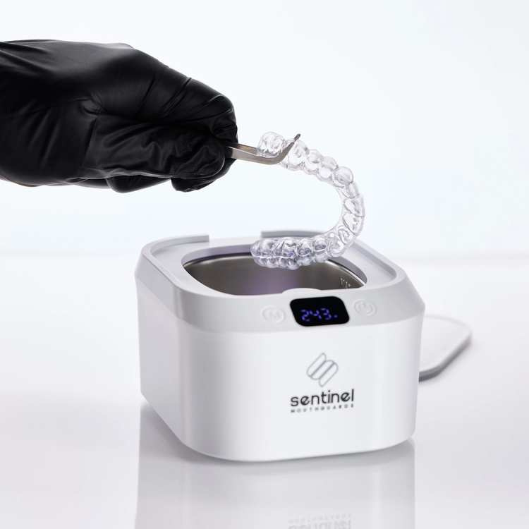 Using an ultrasonic cleaning device to remove yellow stains from a night guard