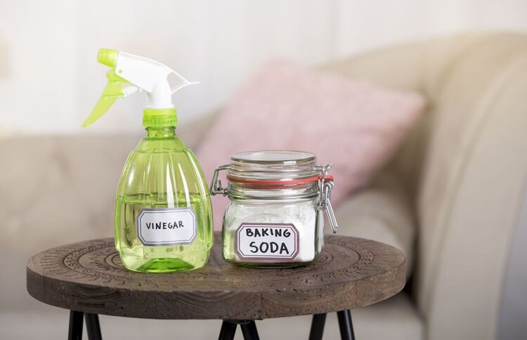 white vinegar in spray bottle and baking soda in glass jar; at-home solution for cleaning a night guard