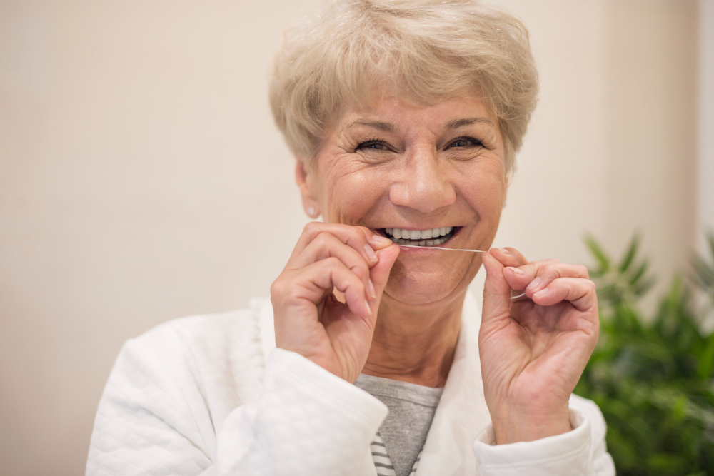 woman flossing her teeth happily