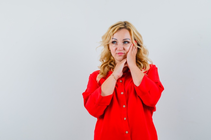 Woman experiencing different sensations in her mouth as the dental numbness gradually wears off